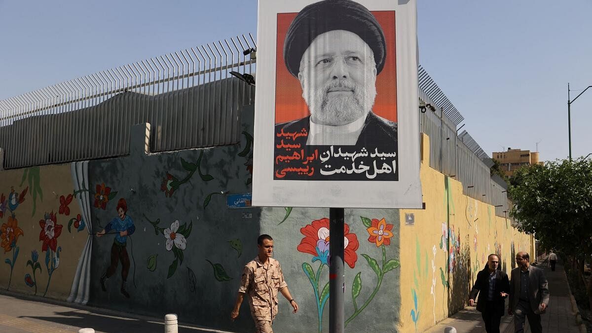 <div class="paragraphs"><p>A banner with a picture of the late Iran's President Ebrahim Raisi is seen on a street in Tehran.</p></div>