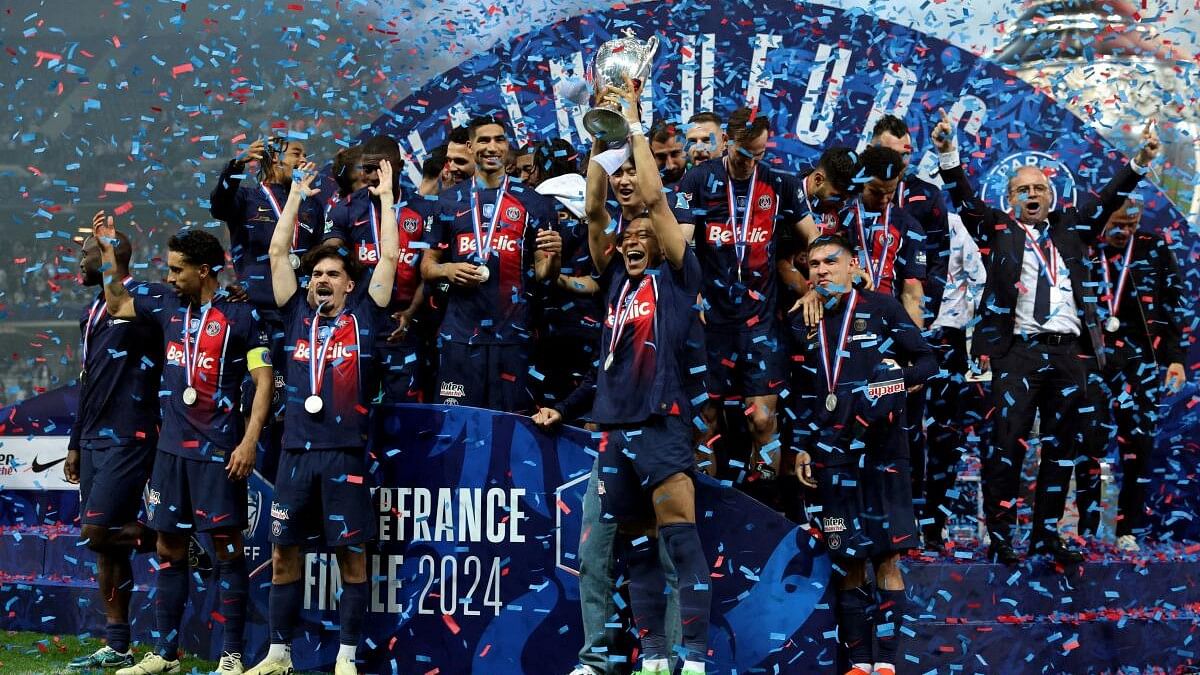 <div class="paragraphs"><p>Paris St Germain's Kylian Mbappe holds the trophy as they celebrate winning the Coupe de France</p></div>