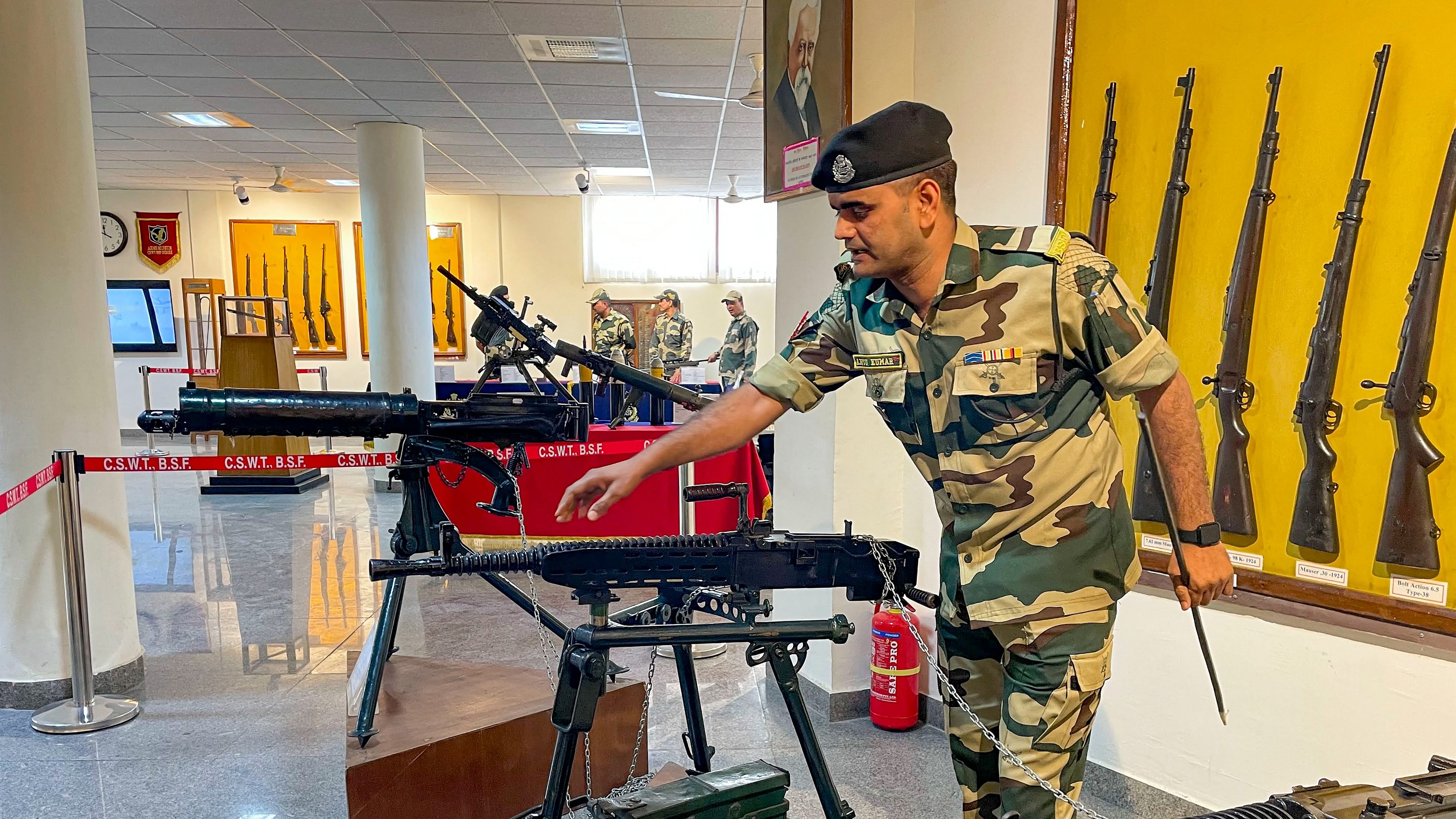 <div class="paragraphs"><p>A Border Security Force (BSF) personnel displays vintage weapons exhibited at an arms museum of the Central School of Weapons and Tactics (CSWT) in Indore.</p></div>