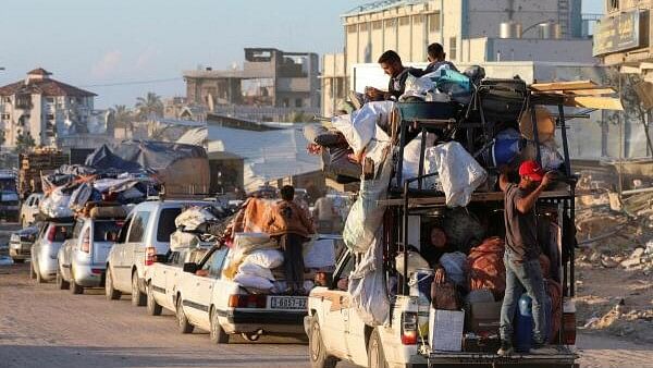 <div class="paragraphs"><p>Displaced Palestinians who fled Rafah, ahead of a threatened Israeli assault, travel in Khan Younis.</p></div>