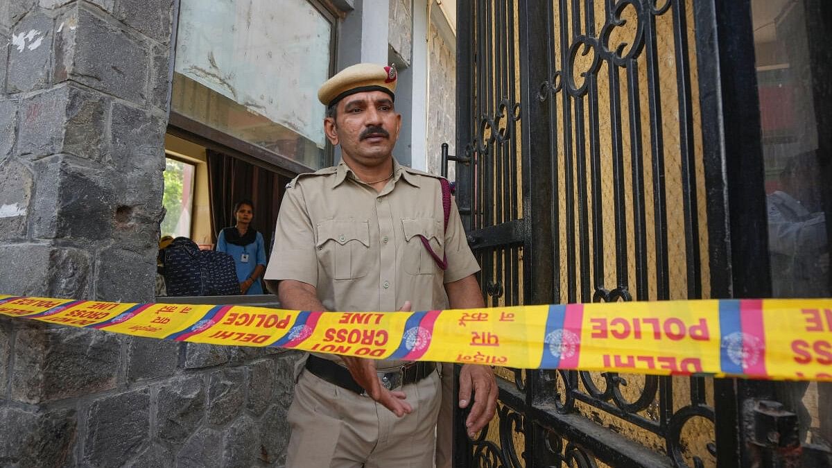 <div class="paragraphs"><p>A police personnel exits the Mother Mary’s School, Mayur Vihar after multiple schools received bomb threats via e-mail, in New Delhi.</p></div>