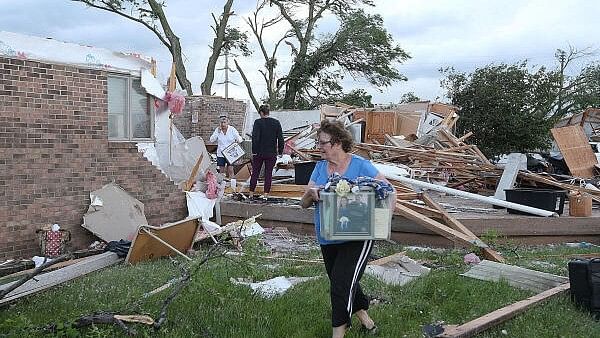 <div class="paragraphs"><p>Volunteers clean up after a tornado touched down in Nevada, Iowa, US.</p></div>