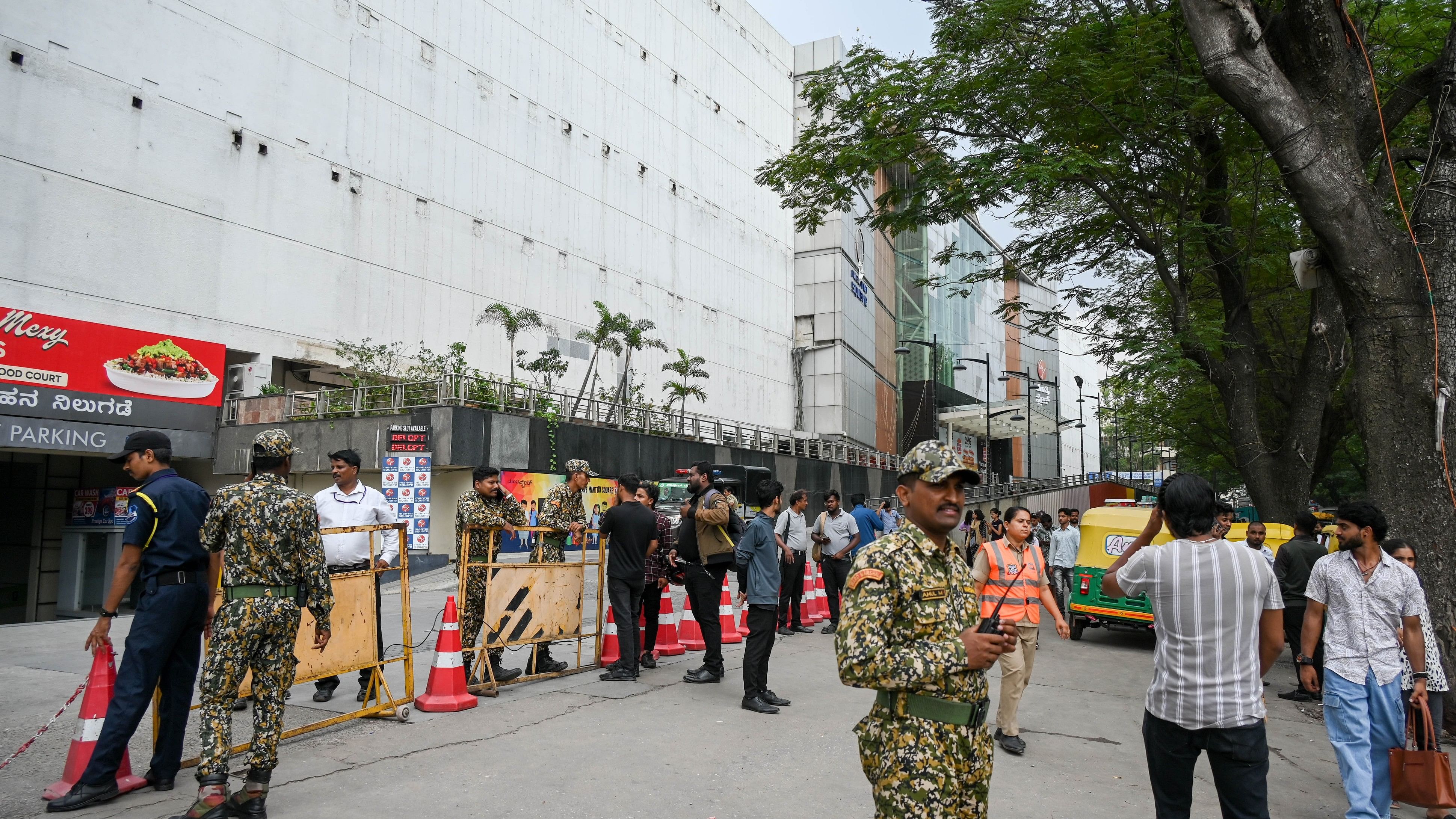 A retinue of civic officials, policemen, and marshals locked the entrance and a few shops inside the mall on Friday. DH PHOTO/BH SHIVAKUMAR 