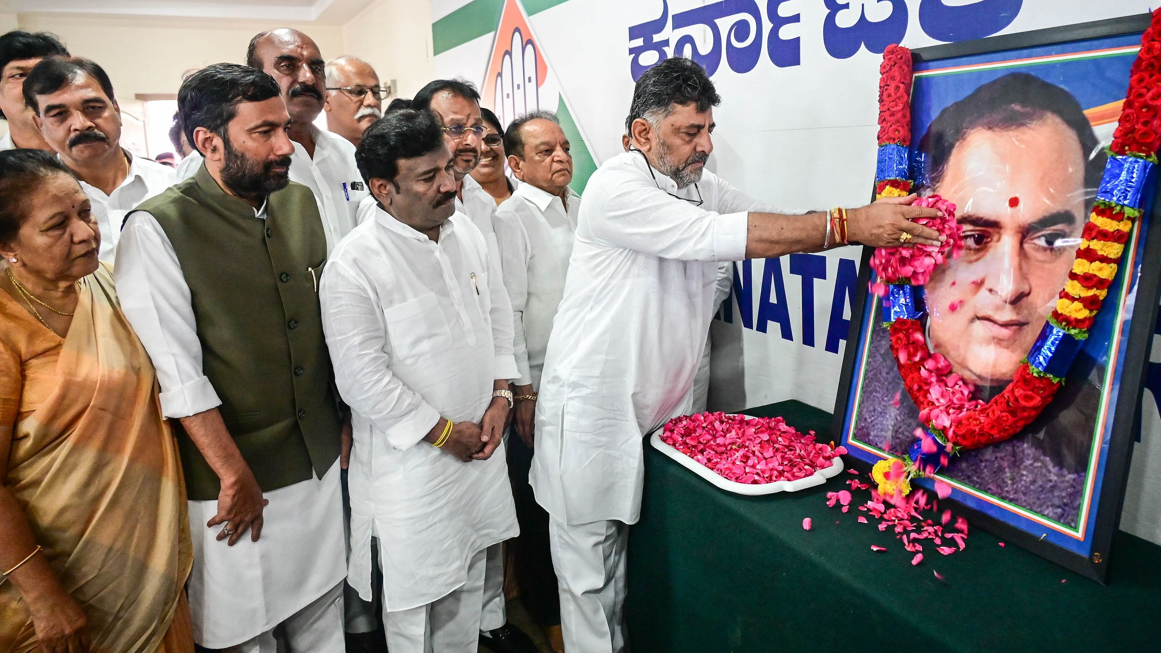 <div class="paragraphs"><p>KPCC president and Deputy Chief Minister D K Shivakumar pays floral tributes to a portrait of former prime minister Rajiv Gandhi on his death anniversary in Bengaluru on Tuesday. </p></div>