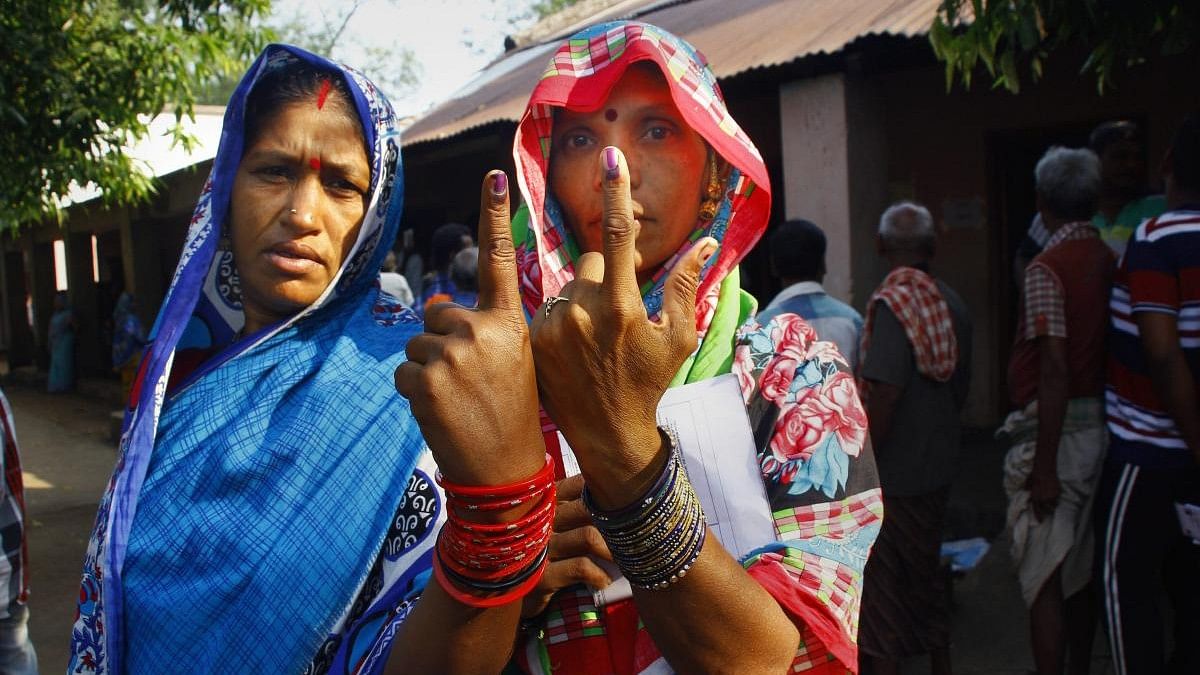 <div class="paragraphs"><p>Voters show their finger marked with indelible ink after casting vote for the second phase of the general elections, at a polling station , Panchabhuti in Ganjam district, Thursday, April 18, 2019. </p></div>