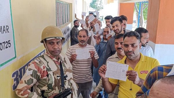 <div class="paragraphs"><p>People wait to cast votes at a polling station during sixth phase of Lok Sabha polls, at Dhangri village in Rajouri district.</p></div>