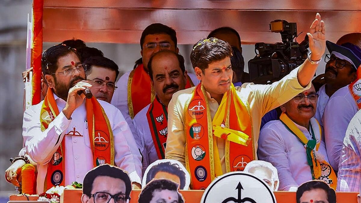 <div class="paragraphs"><p>Maharashtra CM Eknath Shinde with Shiv Sena (Shinde faction) candidate Skrikant Shinde at a roadshow before the latter filed his nomination papers for Lok Sabha polls, in Kalyan, Mumbai.</p></div>