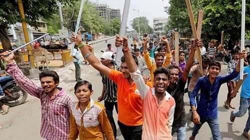 <div class="paragraphs"><p>Dalit community member   protesting after four men  were beaten up while trying to skin a dead cow in Una town in Gujarat.</p></div>