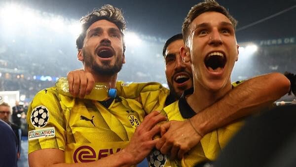 <div class="paragraphs"><p>Borussia Dortmund's Mats Hummels, Emre Can and Nico Schlotterbeck celebrate after the match.</p></div>