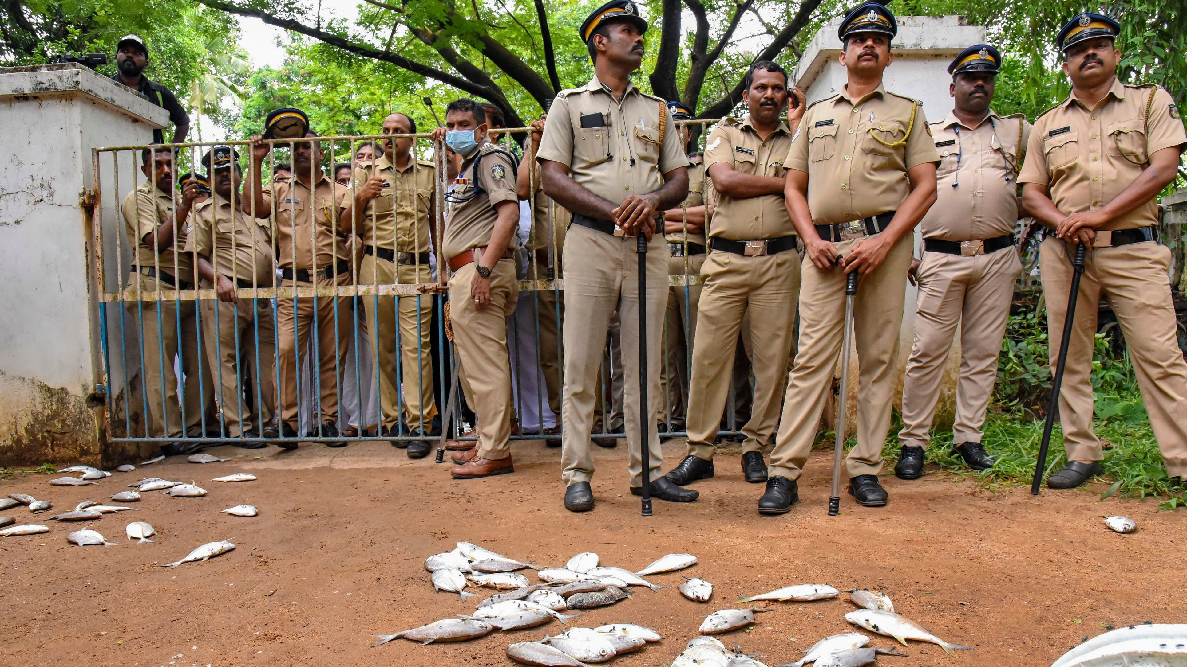 <div class="paragraphs"><p>Police personnel stand near dead fish thrown by farmers, locals and environmental activists during a protest against the death of thousands of fish allegedly due to factories discharging chemical waste into Periyar river, in Kochi, Wednesday, May 22, 2024.</p></div>