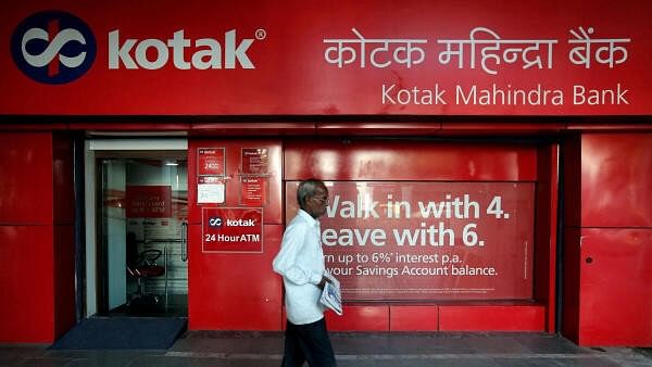 <div class="paragraphs"><p> A man walks past the Kotak Mahindra Bank branch in New Delhi</p></div>