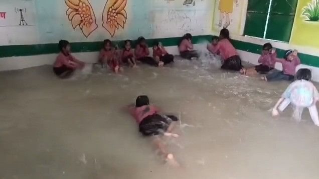 <div class="paragraphs"><p>In the video, students can be seen enjoying their little DIY swimming pool that the teachers had made for them by removing all the tables and chairs from the class and filling water within the boundaries of the room.</p></div>