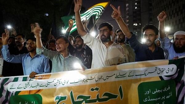 <div class="paragraphs"><p>People hold a banner as they chant slogans in support of an alliance of civil rights groups protesting in Pakistan-ruled Kashmir, demanding the government give the region a subsidy on electricity and wheat prices in the face of rising inflation, during a demonstration in Karachi, Pakistan.</p></div>