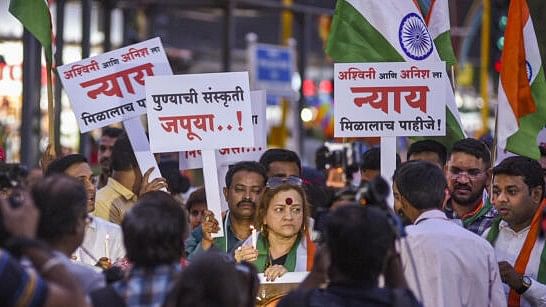 <div class="paragraphs"><p>People take part in a candlelight vigil march to pay condolences to motorbikers who were killed after being knocked down by a porsche car, in Pune, Friday, May 24, 2024. </p></div>