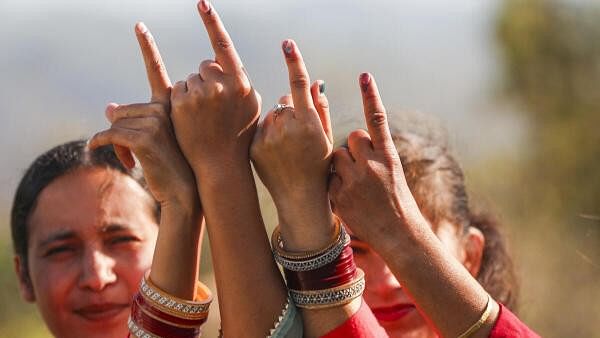 <div class="paragraphs"><p>People show their inked fingers after casting their votes during the sixth phase of Lok Sabha elections, along the Line of Control (LoC) at Nowshera, in Rajouri district.</p></div>