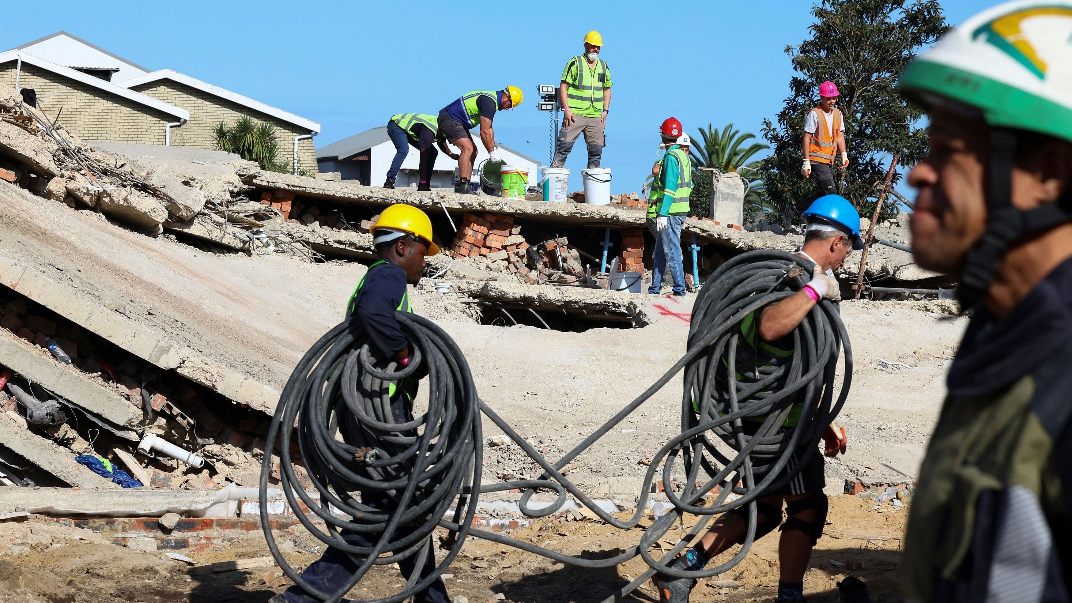 <div class="paragraphs"><p>Rescuers work to rescue construction workers trapped under a building that collapsed in George, South Africa.</p></div>