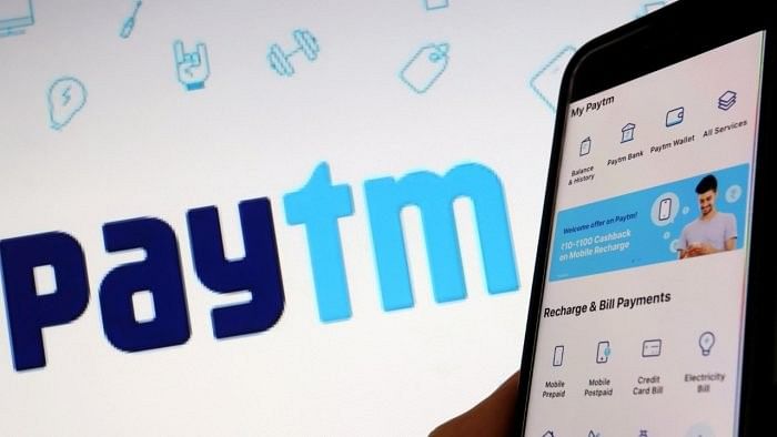 <div class="paragraphs"><p> Paytm logo and a smartphone with the app is seen here.&nbsp;</p></div>