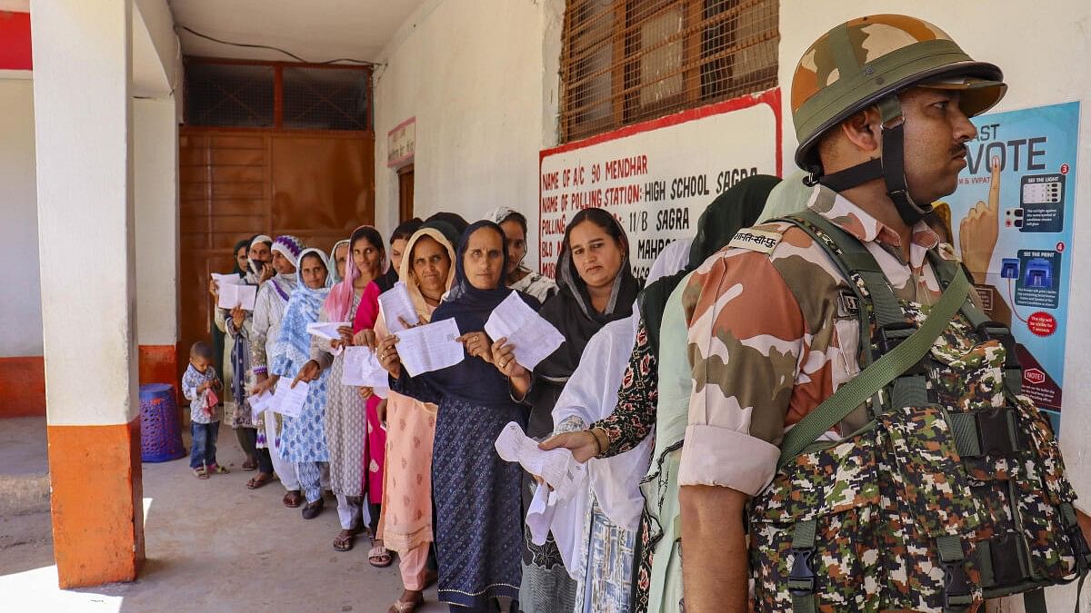 <div class="paragraphs"><p>People wait in a queue at a polling station during sixth phase of Lok sabha elections in Poonch.&nbsp;</p></div>