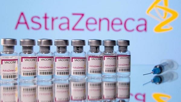 <div class="paragraphs"><p>Vials labelled 'Astra Zeneca Covid-19 Coronavirus Vaccine' and a syringe are seen in front of a displayed AstraZeneca logo.</p></div>