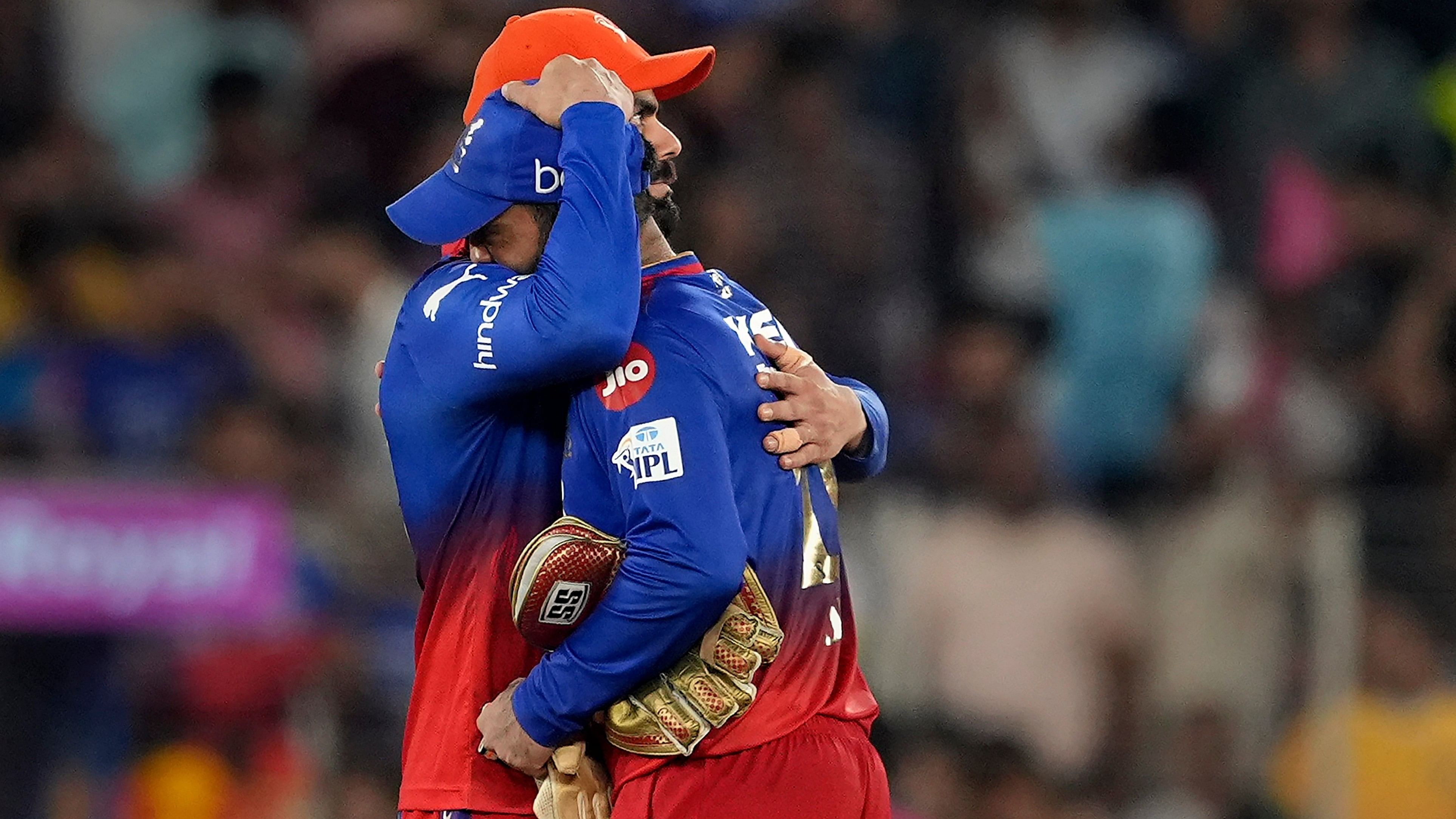 <div class="paragraphs"><p>Virat Kohli and Dinesh Karthik hug each other after the match between Royal Challengers Bangaluru and Rajasthan Royals, at the Narendra Modi Stadium, in Ahmedabad.</p></div>