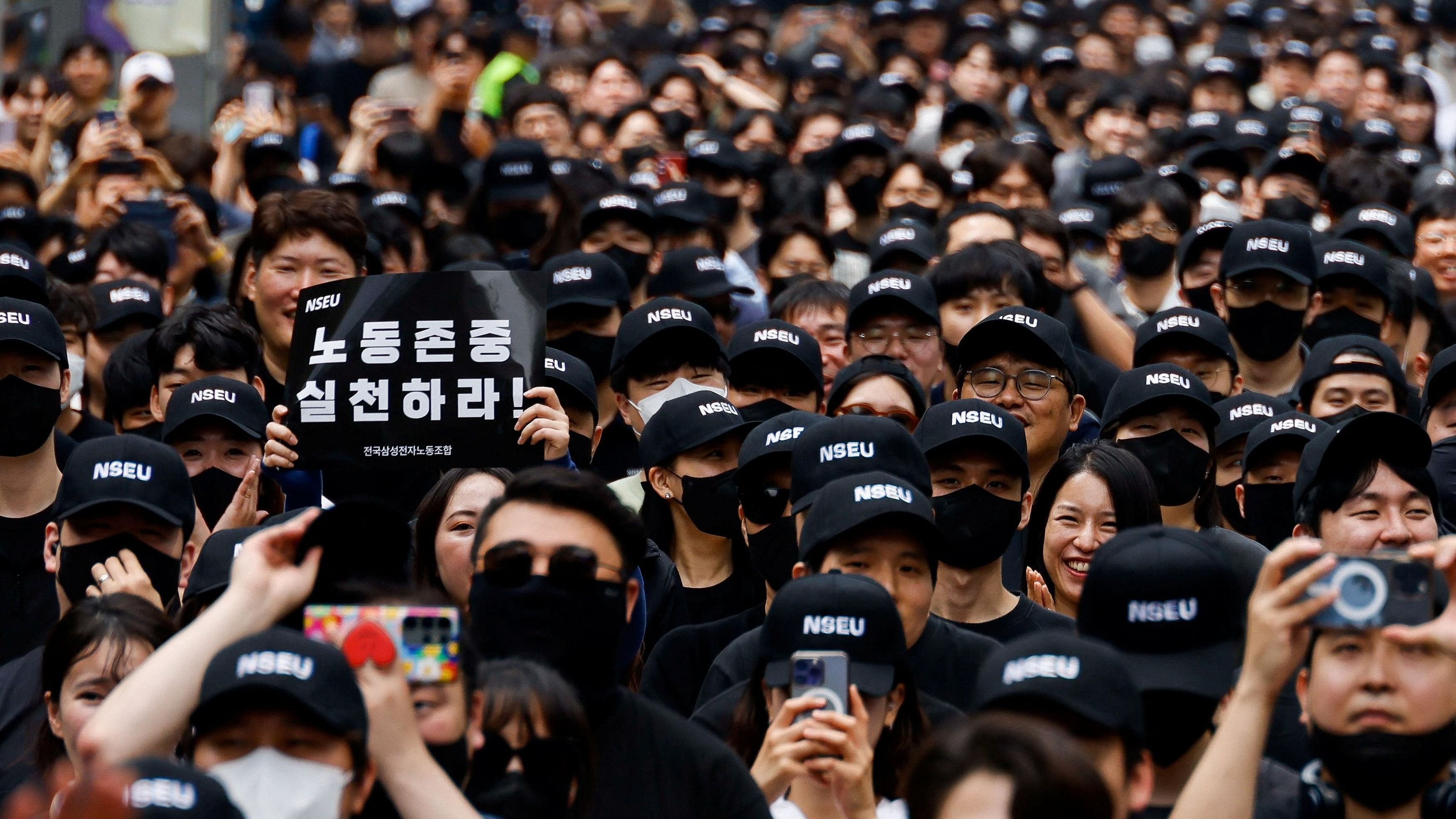 <div class="paragraphs"><p>A member of the National Samsung Electronics Union  holds a placard that reads "Respect labour" in front of the Samsung Electronics Seocho Building in Seoul, South Korea.</p></div>