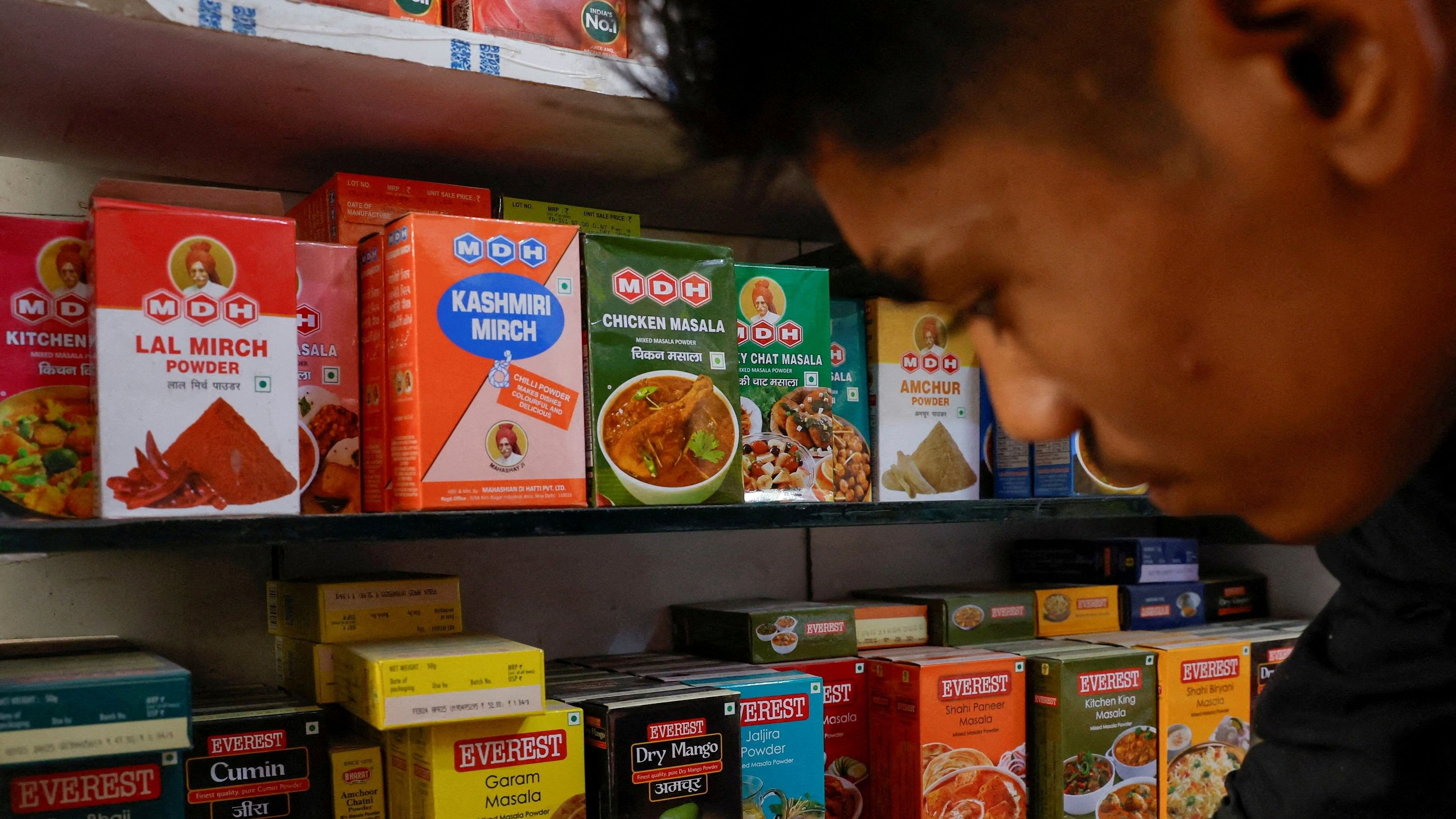 <div class="paragraphs"><p> A man stands near the spice boxes of MDH and Everest kept on the shelf of a shop at a market in New Delhi,  April 29, 2024. </p></div>