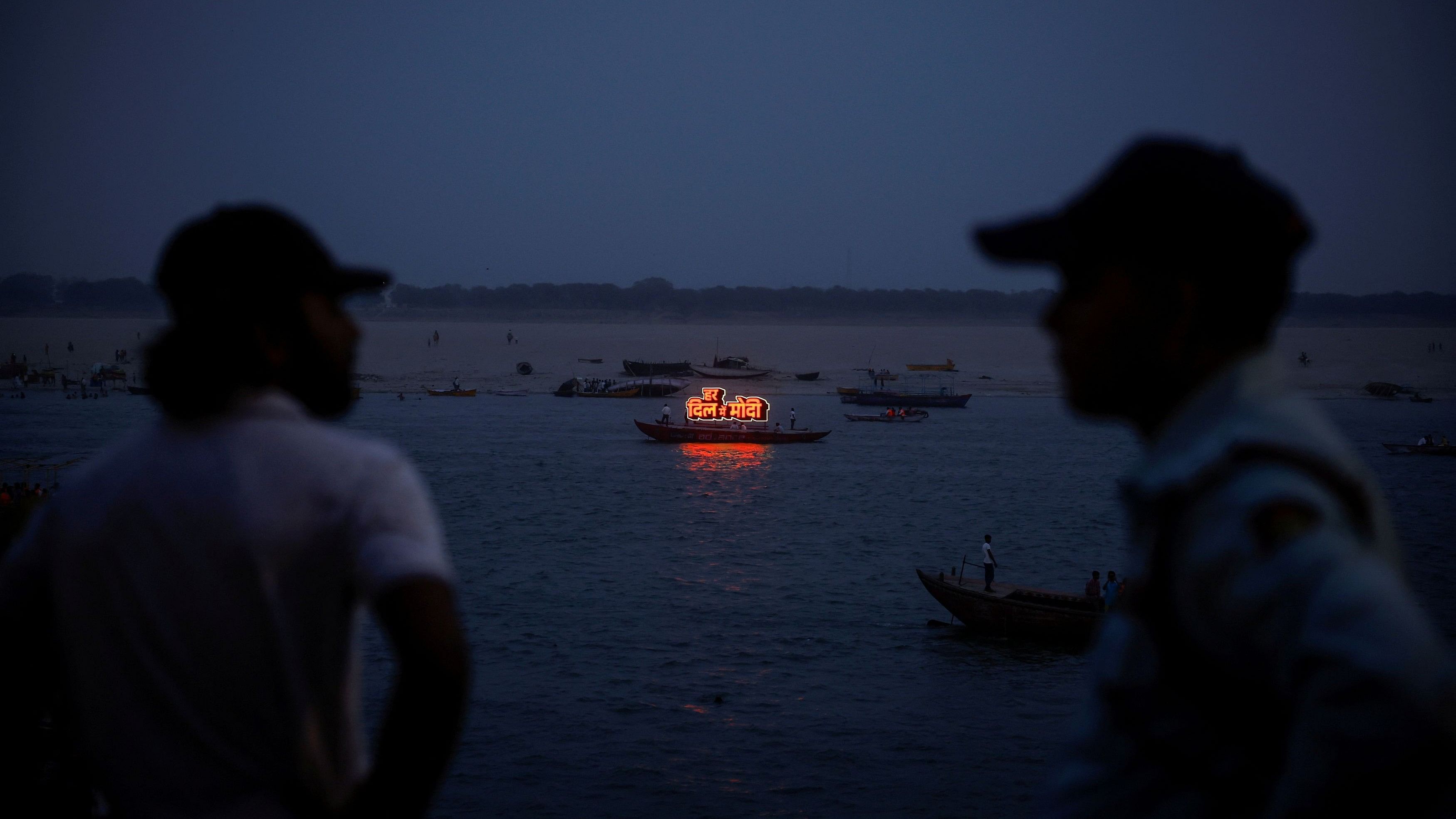 <div class="paragraphs"><p>A boat carries an illuminated message in support of Indian PM Modi on the river Ganges at Varanasi</p></div>