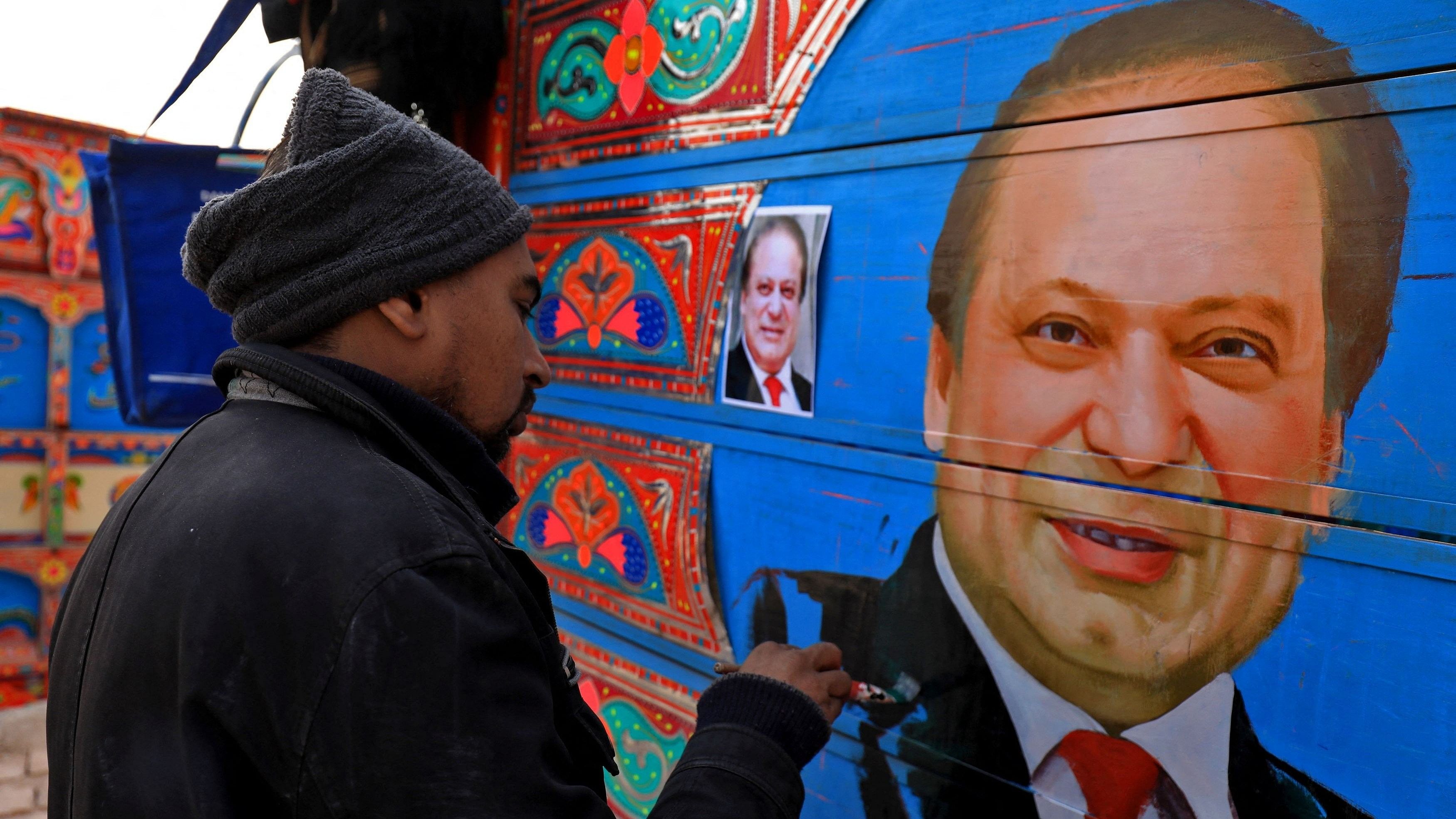 <div class="paragraphs"><p>A truck art painter applies the final touches to a portrait of former  Nawaz Shari.</p></div>