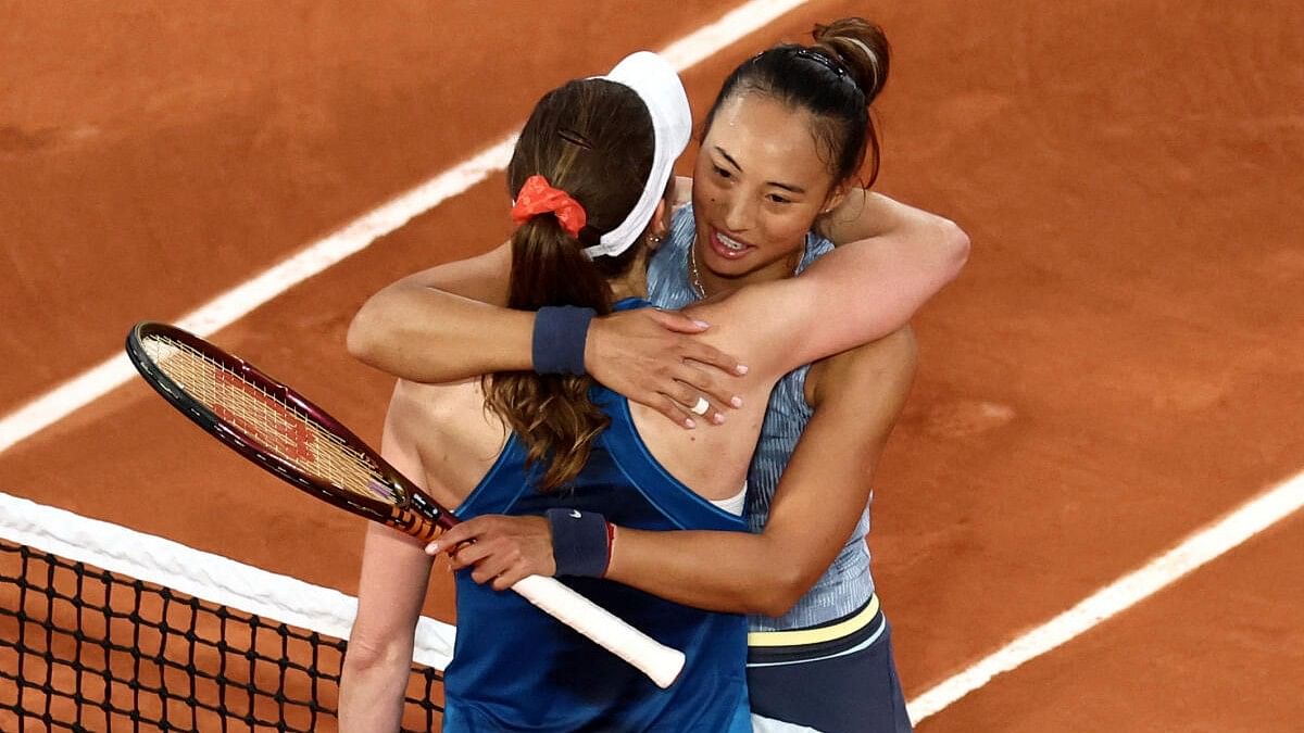 <div class="paragraphs"><p>Qinwen Zheng (right) hugs Alize Cornet after winning her first-round match.</p></div>