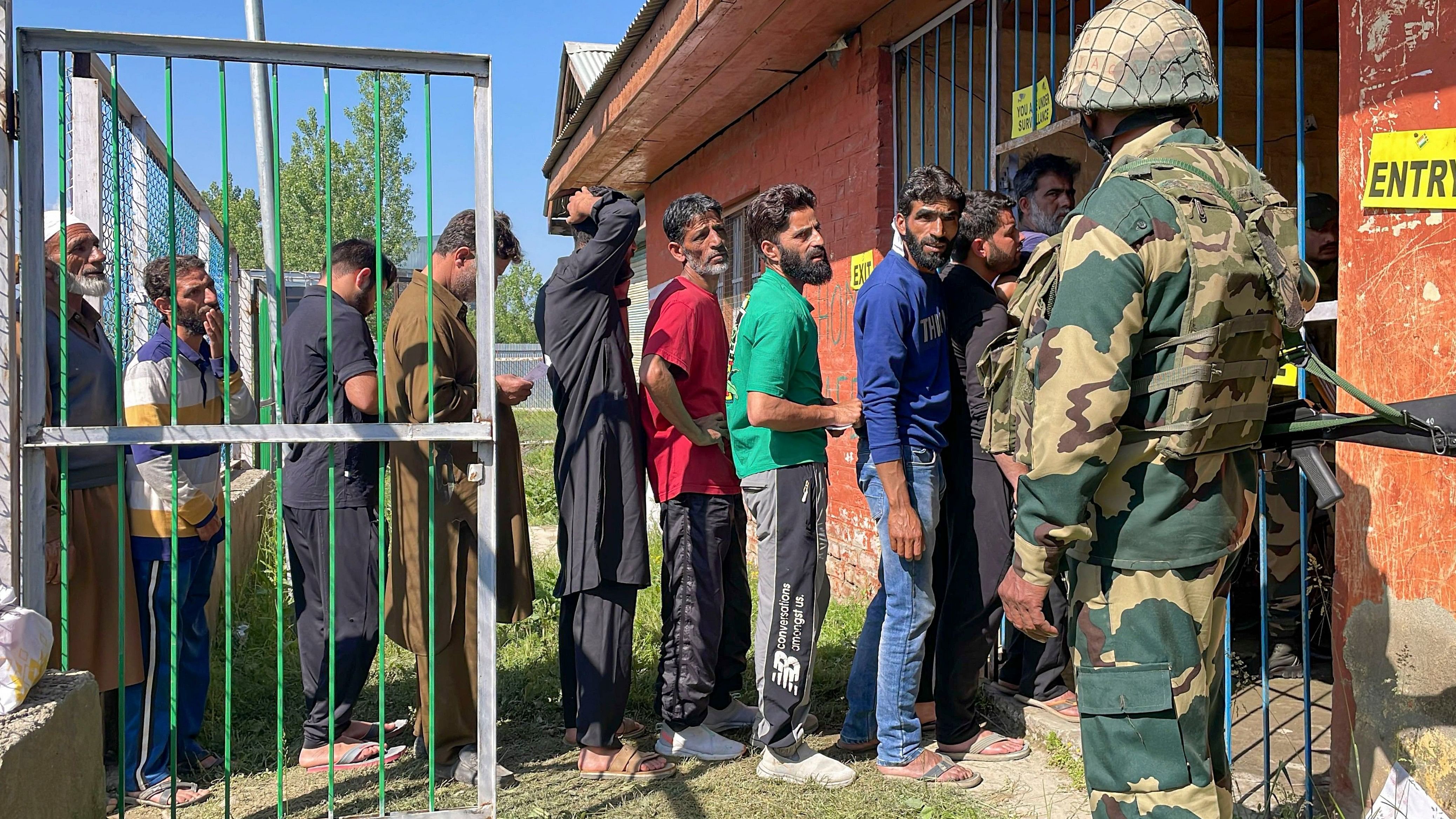 <div class="paragraphs"><p>Sopore: A security personnel stands guard as voters wait in a queue at a polling station to cast their votes for the fifth phase of Lok Sabha elections in Sopore on Monday, May 20, 2024. People come out in large numbers in Sopore in North Kashmir, once known as a hot bed of militancy. </p></div>