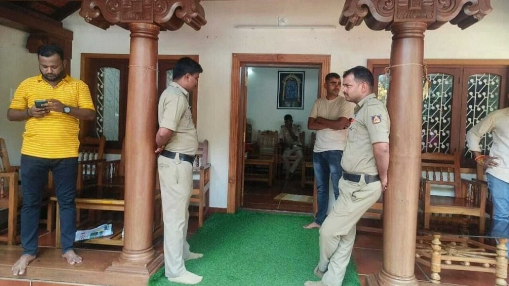 <div class="paragraphs"><p>Police personnel outside the house of MLA Harish Poonja at Gardadi in Belthangady on Wednesday. </p></div>