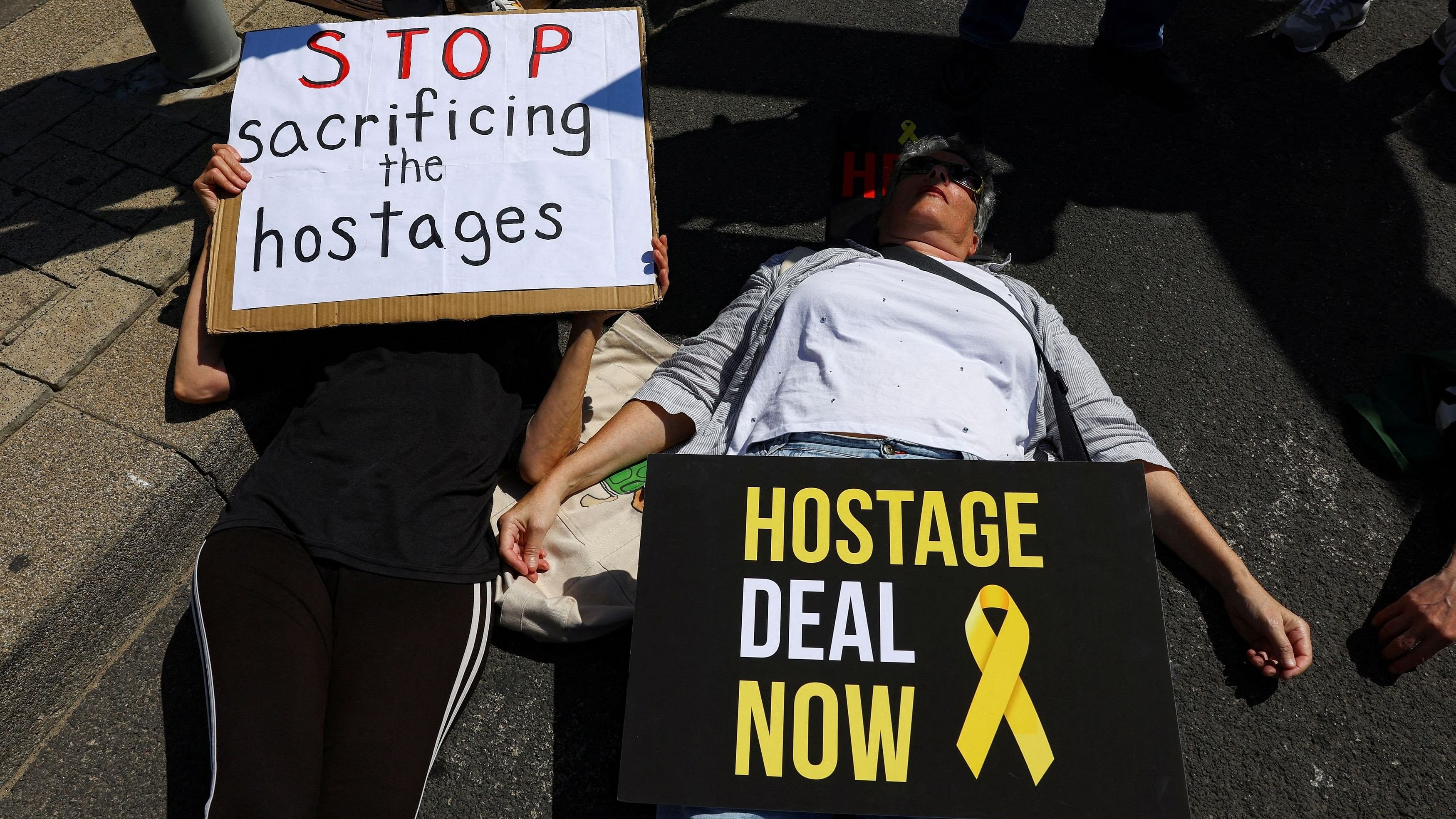 <div class="paragraphs"><p>People lie in the street blocking traffic during a protest calling for a deal and the release of Israeli hostages held in Gaza, amid the ongoing conflict between Israel and the Palestinian Islamist group Hamas, outside the US Embassy Branch Office in Tel Aviv, Israel, April 12, 2024. </p></div>