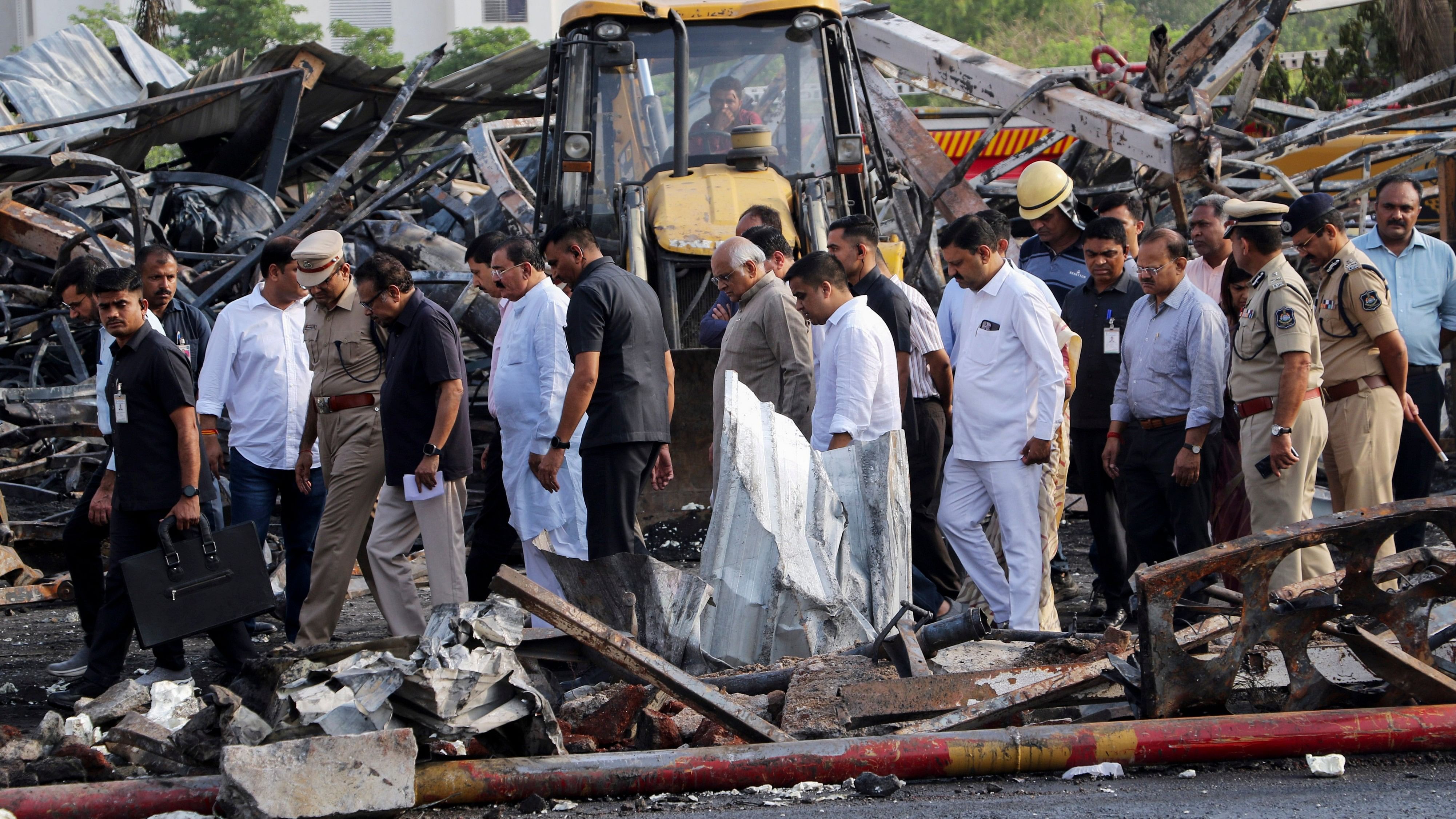 <div class="paragraphs"><p>Gujarat Chief Minister Bhupendra Patel with Union Minister of State Harsh Sanghavi and other officials at the game zone site where a major fire on Saturday evening killed at least 27 people and injured three, in Rajkot.</p></div>