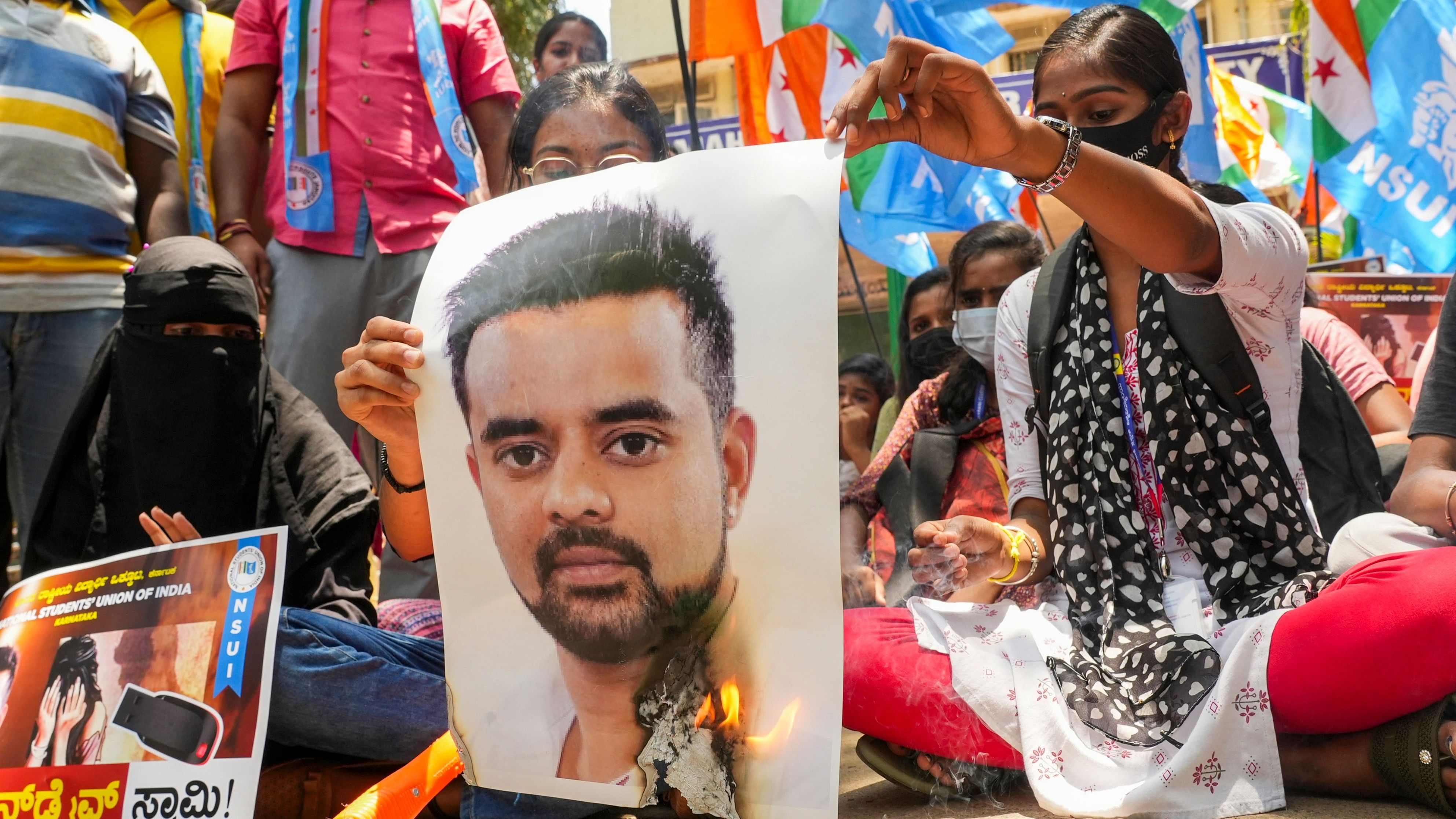 <div class="paragraphs"><p>Bengaluru: NSUI members burn a poster of JD(S) MP Prajwal Revanna during a protest against his involvement in the alleged sexual abuse case, in Bengaluru.&nbsp;</p></div>