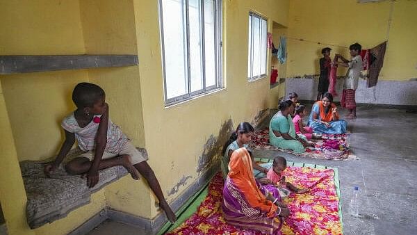 <div class="paragraphs"><p>Locals take shelter at a relief camp, ahead of the landfall of Cyclone 'Remal', at Frazerganj of Namkhana, in South 24 Parganas district in West Bengal.&nbsp;</p></div>