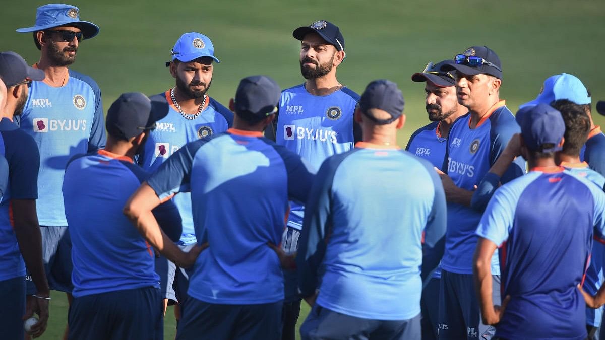 <div class="paragraphs"><p>Indian captain Rohit Sharma with head coach Rahul Dravid and other teammates during a practice session.</p></div>