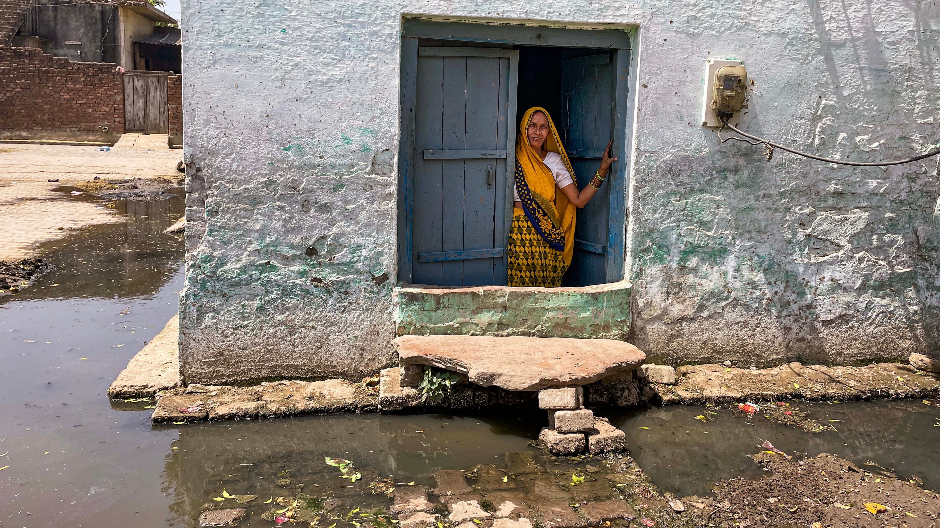 <div class="paragraphs"><p>A woman peeps out of her window in a village in Hathras, Uttar Pradesh.</p></div>