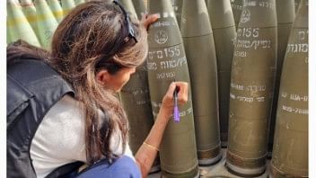 <div class="paragraphs"><p>Failed Republican presidential nominee Nikki Haley signs Israeli shells during her visit in Israel.</p></div>