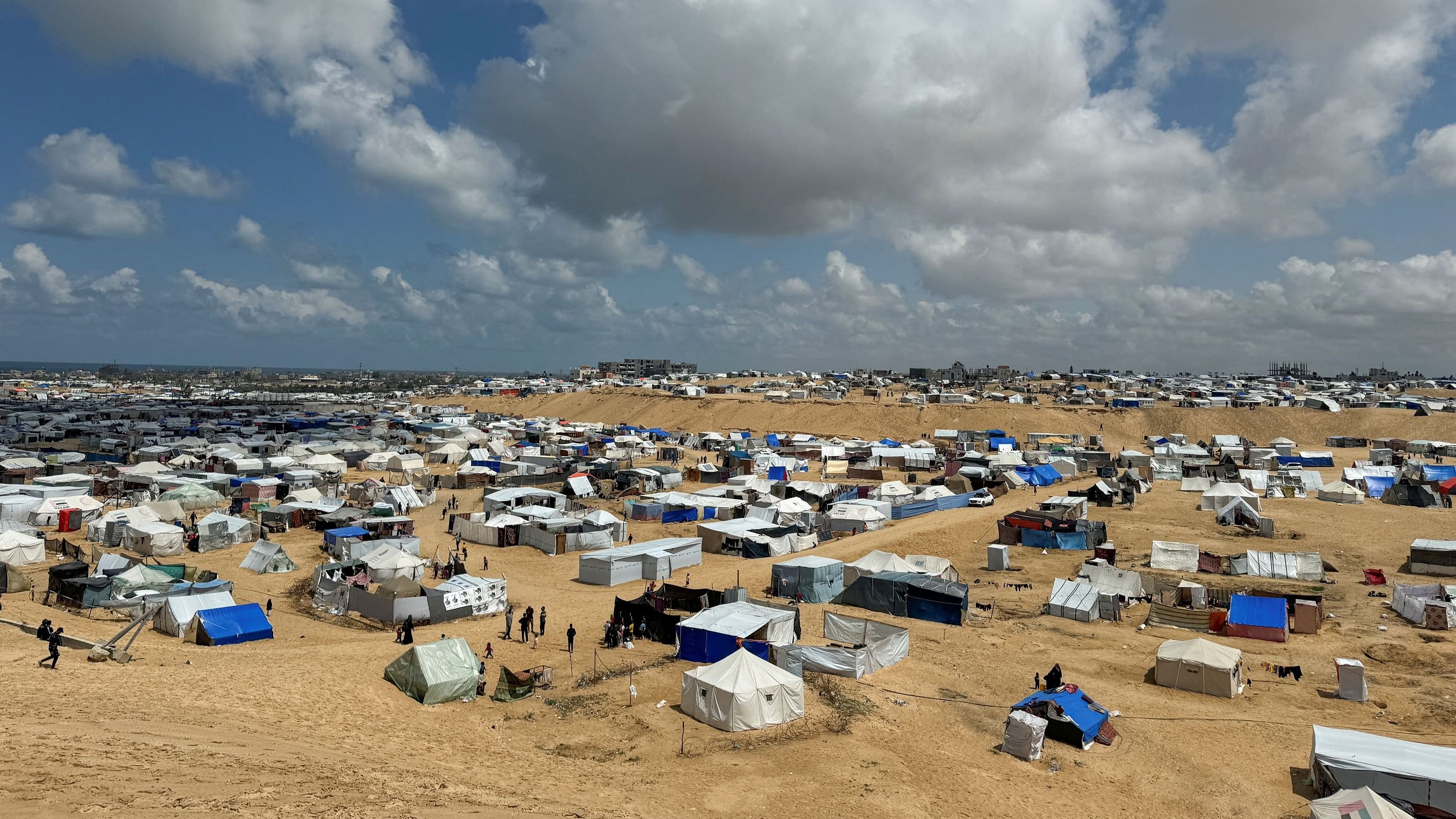 <div class="paragraphs"><p>Palestinians who fled their houses due to Israeli strikes, take shelter in a tent camp amid the ongoing conflict between Israel and  Hamas at the border with Egypt in Rafah, in southern Gaza Strip.</p></div>