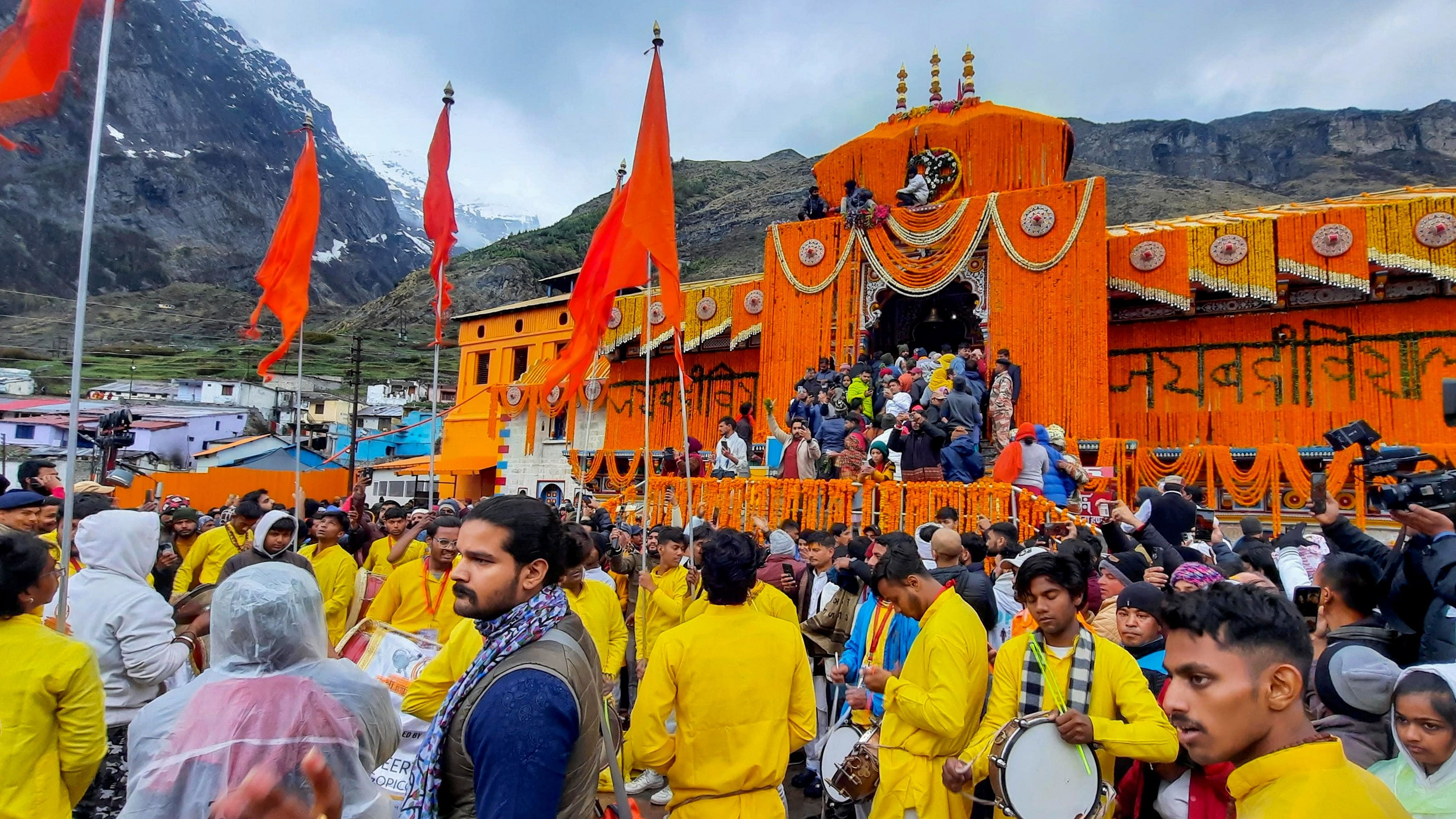 <div class="paragraphs"><p>Devotees arrive at the Shri Badrinath temple after its portals were opened, in Chamoli district, Sunday morning, May 12, 2024.</p></div>