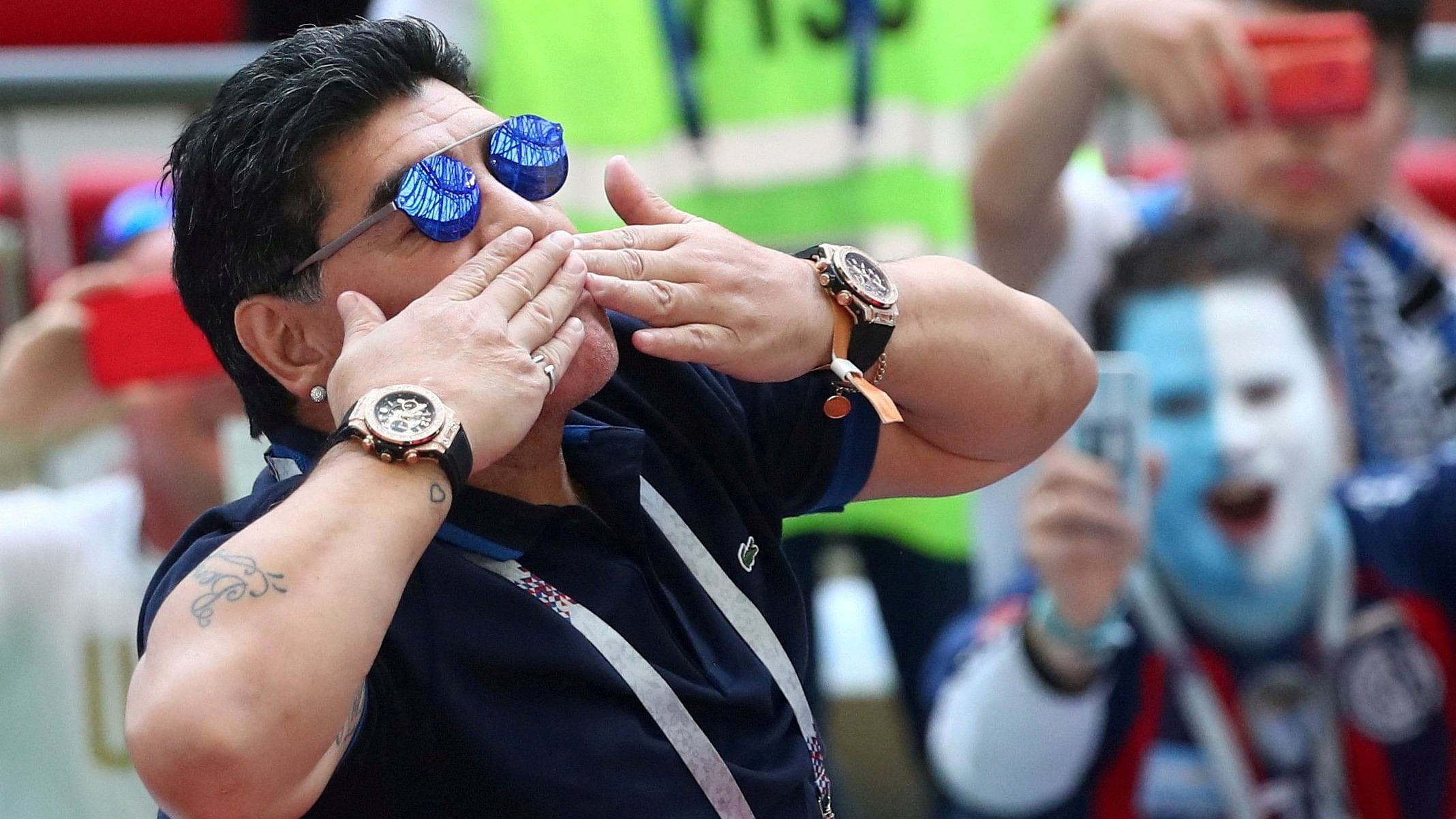 <div class="paragraphs"><p>  Diego Maradona in the stands before a match.</p></div>