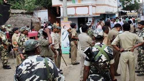 <div class="paragraphs"><p>Security personnel stand in front of a polling booth after an incident of violence during polls.&nbsp;</p></div>