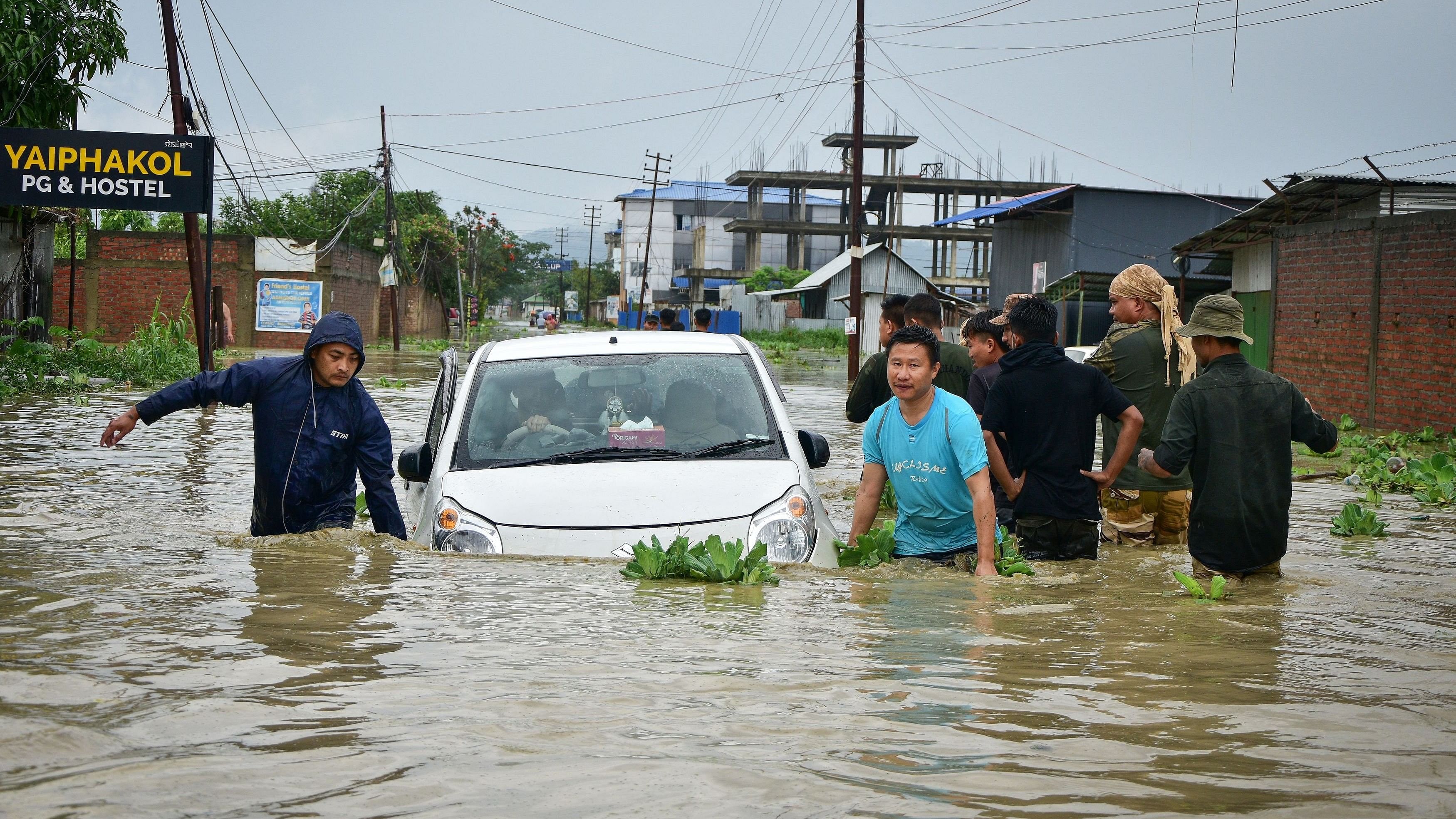 <div class="paragraphs"><p>People try to pull a submerged car in the flood waters after heavy rains caused by Cyclone Remal in Imphal, Manipur, India, May 29, 2024. r</p></div>