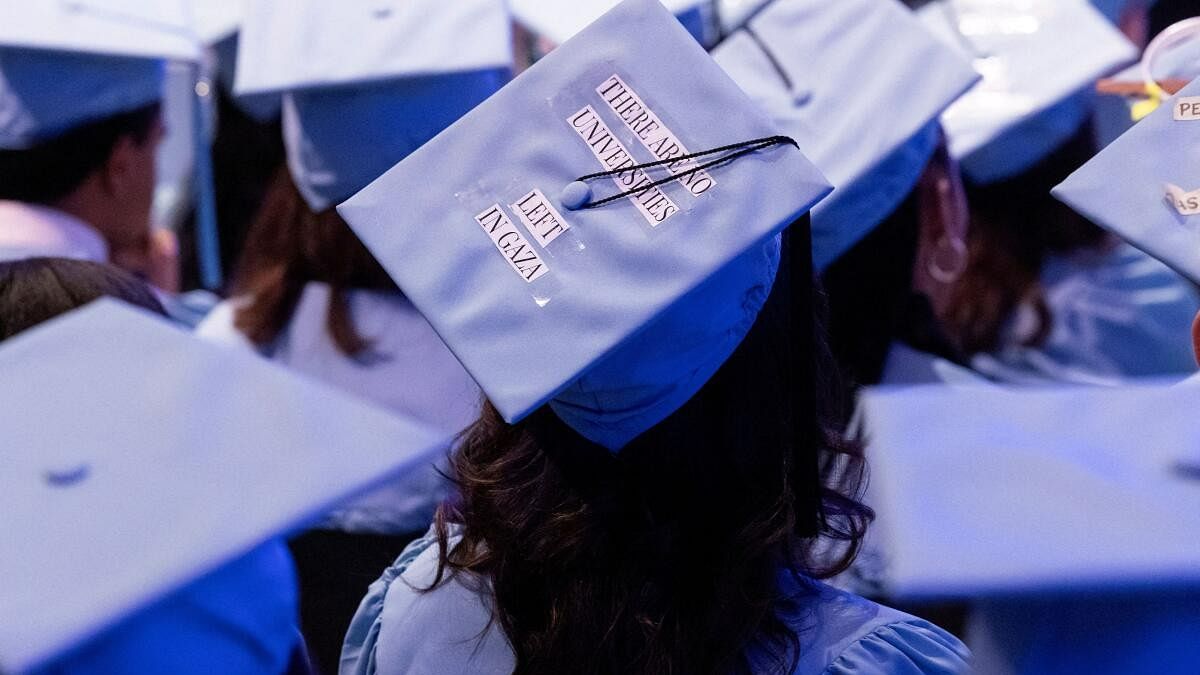 <div class="paragraphs"><p>A student wears a statement on their cap in support of Palestinians during a graduation ceremony at Columbia University Journalism School, during the ongoing conflict between Israel and the Palestinian Islamist group Hamas, in New York City, US, May 15, 2024. </p></div>