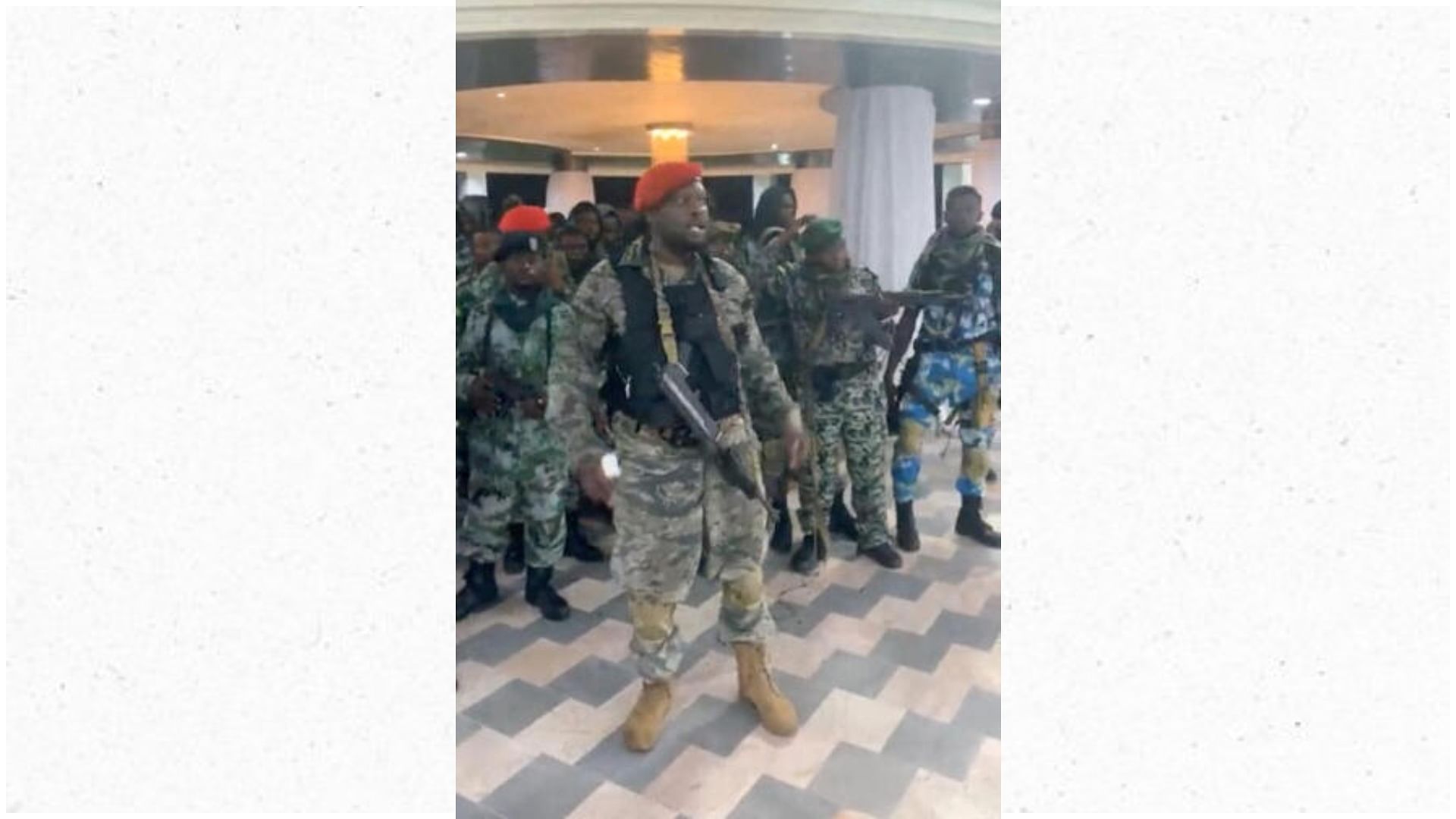 <div class="paragraphs"><p>A man in military fatigues speaks inside the Palace of the Nation during an attempted coup in Kinshasa.</p></div>