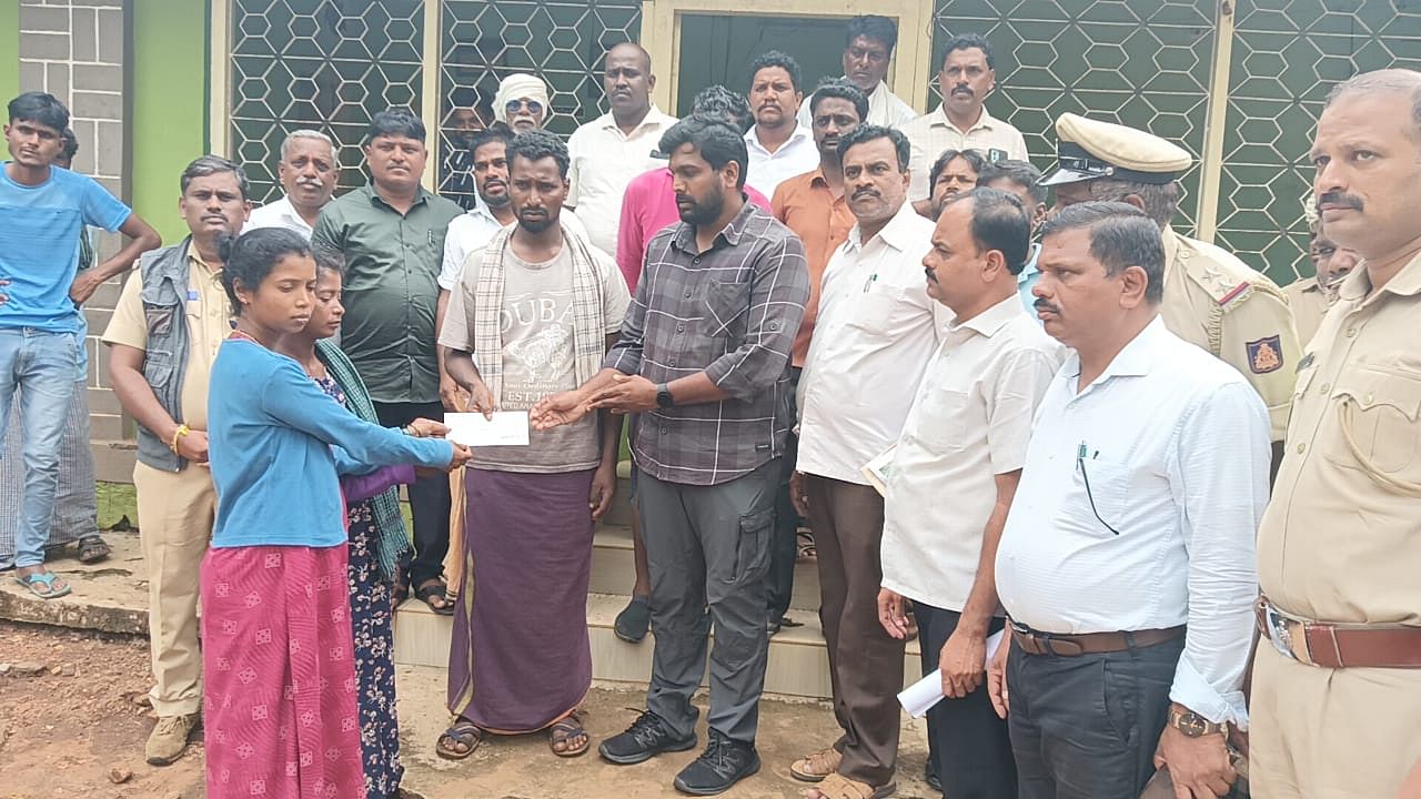 Forest officials hand over compensation to the family members of Chikki who died due to tiger attack in HD Kote taluk. 