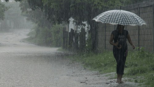 <div class="paragraphs"><p>Representative image showing a woman walk by a street in Mangaluru during rain.</p></div>