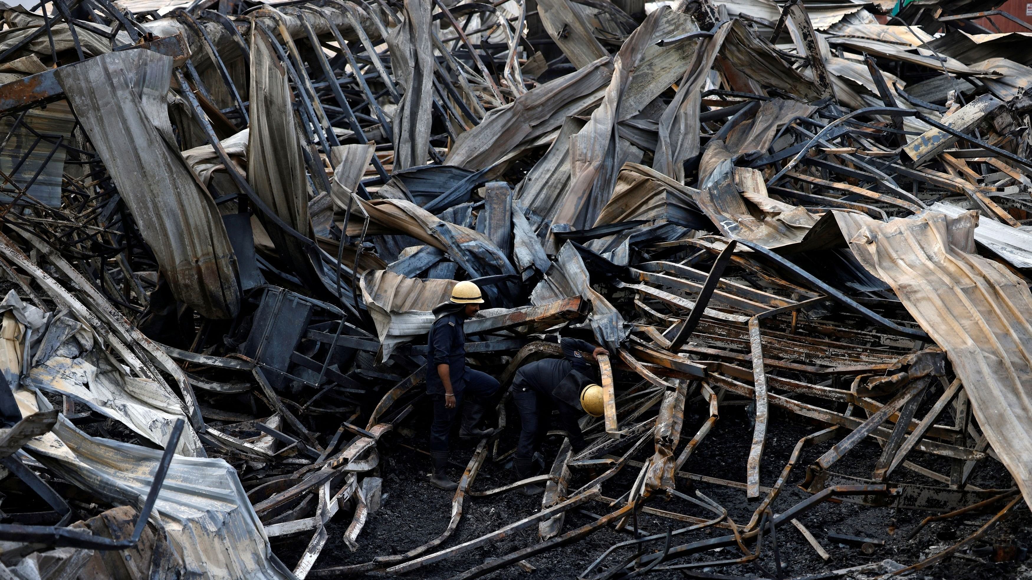 <div class="paragraphs"><p>Firefighters search for victims amidst the debris following a fire in a gaming zone in Rajkot, Gujarat.</p></div>