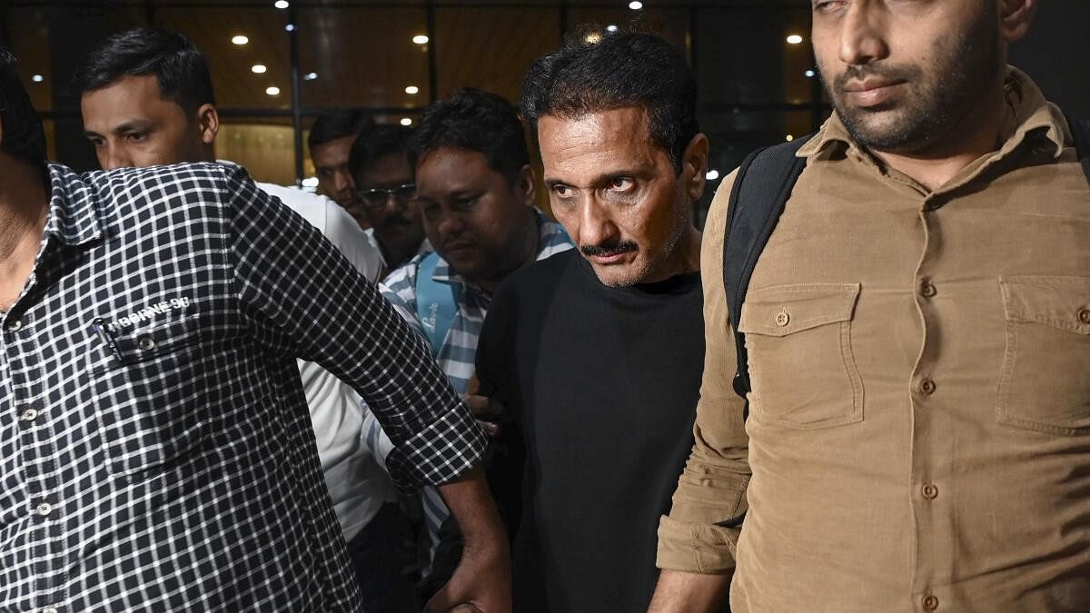 <div class="paragraphs"><p>Mumbai Police Crime Branch team brings Bhavesh Bhinde, an accused in the Ghatkopar hoarding collapse case, from Udaipur, at the Mumbai Airport on Thursday late night, May 16, 2024. Bhinde's company put up the giant billboard in Ghatkopar whose collapse claimed 16 lives.</p></div>