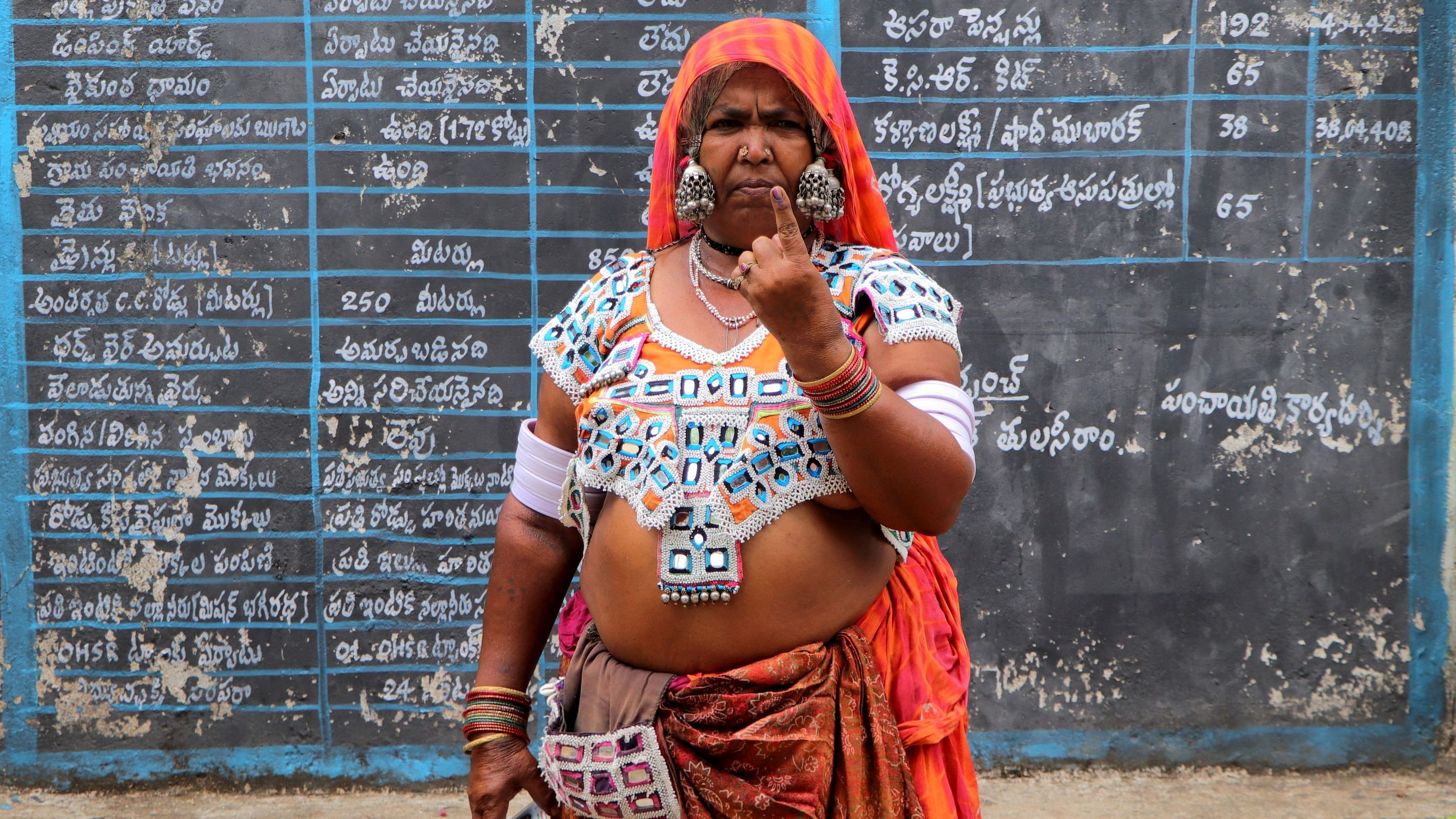 <div class="paragraphs"><p>A tribal woman shows her ink-marked finger after casting her vote at a polling station during the fourth phase of India's general election in Rangareddy district in  Telangana.</p></div>